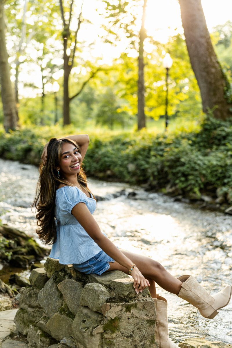 Sitting on stone steps Casual senior photo at the Reading Museum showing natural light and relaxed posing style.